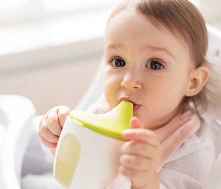Child drinking out of sippy cup